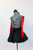 Striped, crop-top with neck-strap and short black, crinoline lined taffeta skirt, wide black patent leather belt, long red gloves and black bow headband. Side