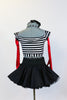 Striped, crop-top with neck-strap and short black, crinoline lined taffeta skirt, wide black patent leather belt, long red gloves and black bow headband. Back