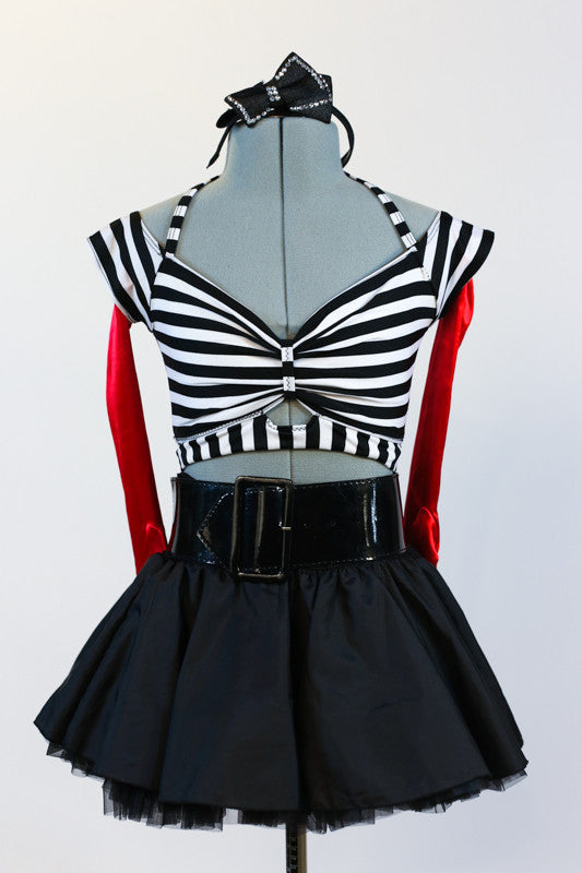 Striped, crop-top with neck-strap and short black, crinoline lined taffeta skirt, wide black patent leather belt, long red gloves and black bow headband. Zoomed