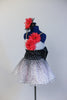 White base has crystal mesh overlay with a cascading spray of black velvet dots over white and  pink tulle. 2 coral daisies on bodice match the hair accessory. Side