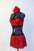 Red sequined bra top has black edging, criss-cross straps and a matching skirt with attacked black shorts. Comes with mini red jazz hat accessory. Side