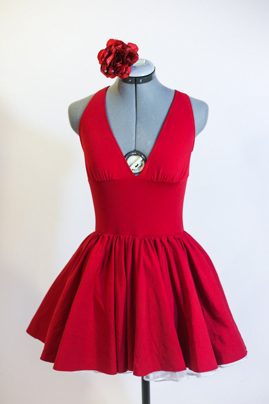 Deep red, halter leotard dress has cross straps, low back, wide waistband, triangle style bust area and gathered skirt. Comes with matching floral hair piece. Front