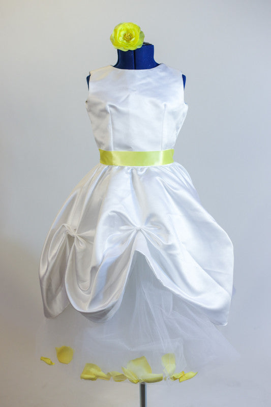 Long white tulle skirt contains yellow rose petals. Tulle shirt sits below white sateen ruched dress with soft yellow satin sash and yellow floral hair piece. Front