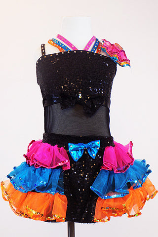 Black sequined &mesh leotard has crystal bow/band accents. Has colourful triple halter straps, pink-turquoise-orange organza ruffled skirt &matching headpiece. Front zoom